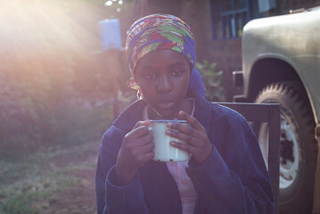 Portrait of a African Teenage Girl cooling her tea