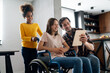 © NDABCREATIVITY - Happy multiethnic family with child with disability in wheelchair