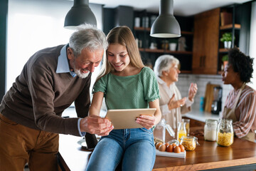 Wall Mural - Portrait of happy multigeneration, multiethnic family having fun in kitchen at home