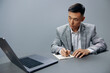 © SHOTPRIME STUDIO - manager writing in a notebook laptop work at the desktop executive