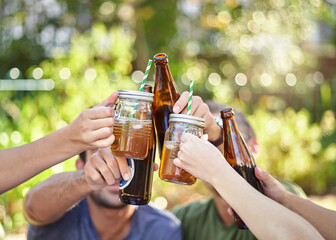 Canvas Print - Cheers to summer. Cropped shot of a young group of friends toasting while enjoying a few drinks outside in the summer sun.