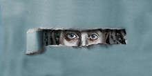 A Female With Blue Eyes Peers Through A Hole Torn In Cardboard In This 3-d Illustration.