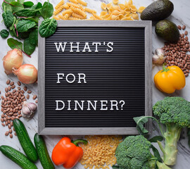 What's for dinner sign on letter board surrounded by food ingredients