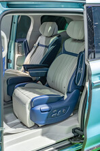 Passenger Seats Of The Van Through The Open Door Of A Blue Automobile. Comfortable And Luxury Transport Saloon Concept.