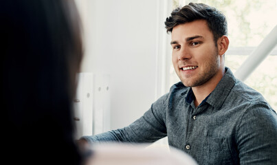 Poster - Seeing results makes me happy. Cropped shot of a handsome young businessman sitting with a colleague in the office during the day.