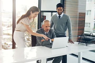 Sticker - Many hands make light work. Cropped shot of three businesspeople working on a laptop in their office.