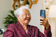 © Nattakorn - Asian old senior making video call via mobile phone talking with family