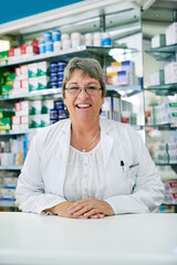 Poster - Speak to me for all of your health related queries. Portrait of a happy mature woman working in a pharmacy.