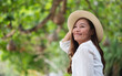 © Farknot Architect - Portrait image of a beautiful young asian woman in white shirt with hat relaxing in the park
