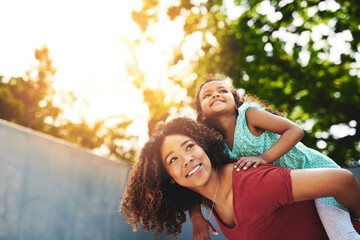 Wall Mural - Where to next, little lady. Shot of a happy little girl and her mother enjoying a piggyback ride in their backyard.