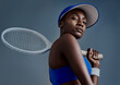 © Nicholas Felix/peopleimages.com - Get up and make it happen. Studio shot of a sporty young woman posing with a tennis racket against a grey background.