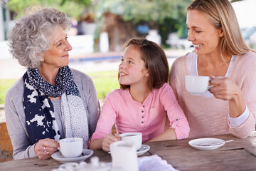 Sticker - Bonding time for the girl. Shot of three generations of the woman of the women of a family having tea outside.