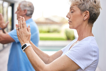 Wall Mural - Yoga will sharpen all your perceptions. Shot of a mature couple meditating together outdoors.