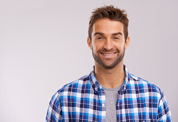 Poster - Rugged and manly. Studio portrait of a handsome man against a gray background.