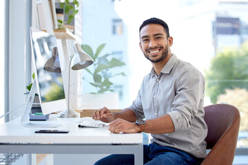 Poster - Ambition never comes to an end. Portrait of a young businessman working on a computer in an office.