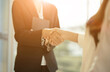 © Natee Meepian - Close up of Business people shaking hands, finishing up meeting, business etiquette, congratulation, merger and acquisition concept