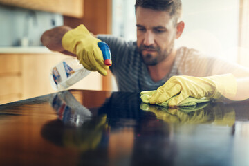 Aufkleber - Germs, aint nobody got time for that. Shot of a young man cleaning the kitchen counter at home.
