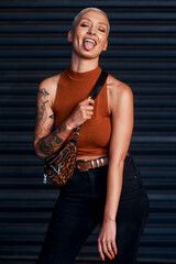 Canvas Print - Hey there silly. Cropped shot of an attractive young woman sticking out her tongue while standing against a dark background.