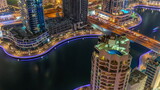 Fototapeta Miasto - Dubai Marina waterfront and city promenade night timelapse from above.