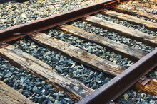 Close-up Of Train Tracks, Steel Rails And Wooden Sleepers