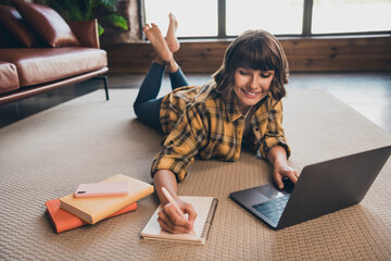 Sticker - Photo of smart concentrated woman lying floor browsing on laptop make notes homework studying at home