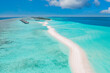 Panoramic landscape seascape aerial view over a Maldives atoll islands. White sandy beach seen from above. Perfect aerial landscape, luxury tropical resort or hotel with water villas beautiful beach