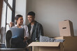 © ReeldealHD images - Mid adult couple moving house and using a laptop