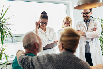 Wall Mural - Group of young doctor during home visit senior people