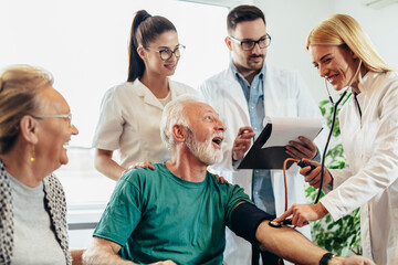 Wall Mural - Group of young doctor during home visit senior people, control blood pressure.