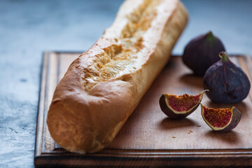 Wall Mural - FRESH CRUNCHING BAGUETTE AND FIGS IN CLOSEUP ON TABLE