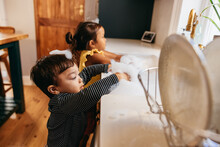 Two Little Toddlers Playing With White Foam At Home
