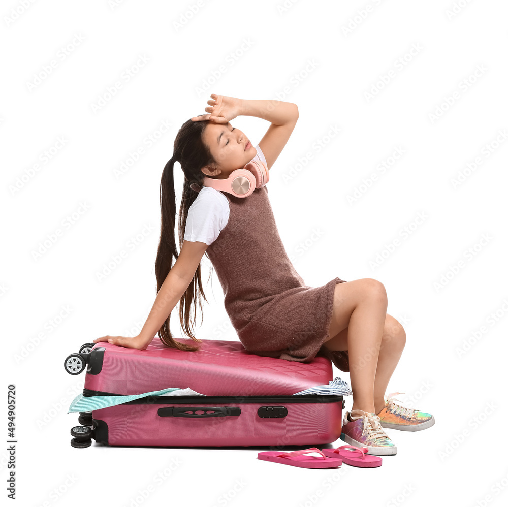 Cute little girl with suitcase on white background