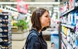 © pavel siamionov - young woman looking at product at grocery store in supermakket. shopping