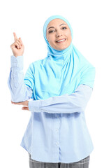 Wall Mural - Portrait of Muslim secretary with raised index finger on white background