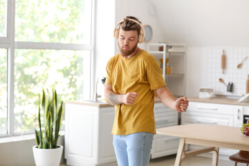 Canvas Print - Cool young man dancing and listening to music at home