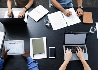 Poster - The right gadgets can give your business a great boost. Shot of a team of businesspeople using various tech devices in their office.