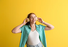 Cool Young Woman Listening To Music On Color Background