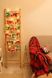 Fototapeta  - Advent calendar, Christmas decor and sofa near wall in room