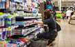 © pavel siamionov - Portrait of young woman choosing school stationery in supermarket.