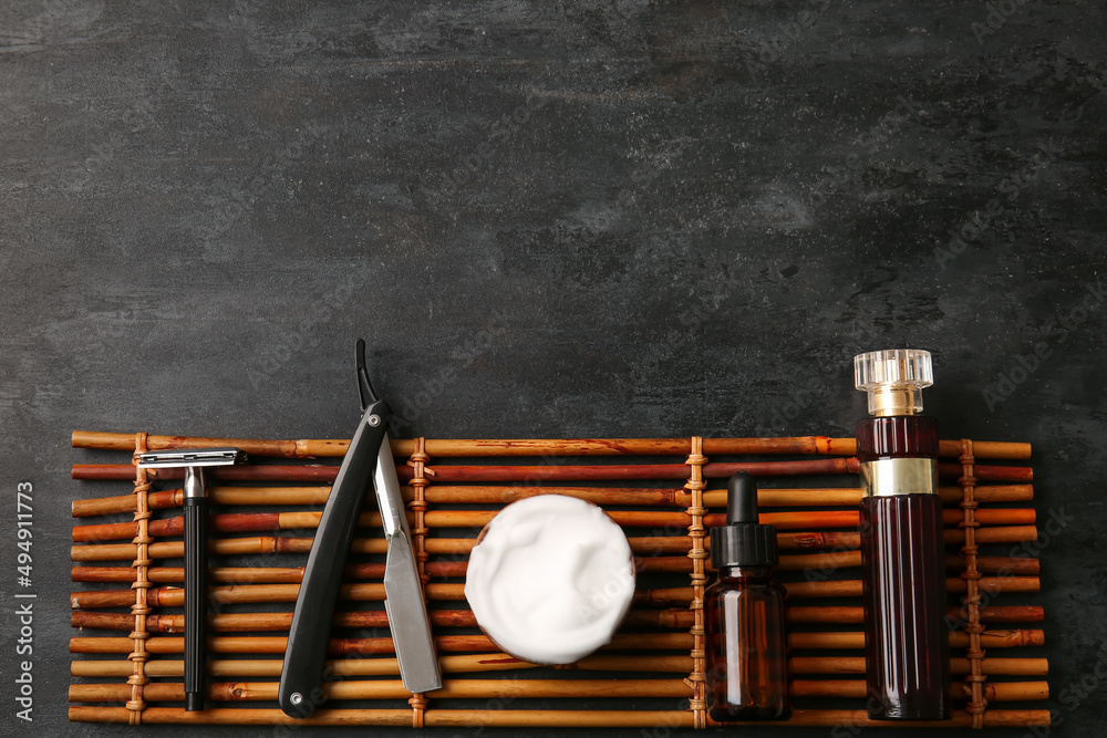 Stylish male accessories for shaving on black background