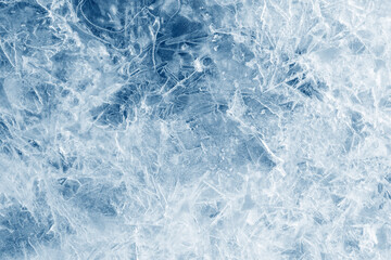 Ice background texture. Frozen water in various geometric abstract shapes. Seasonal natural effect. Cold weather. The surface of the winter water reservoir.