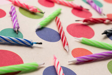 Closeup Shot Of Colorful Candles With Paper Rounds Background