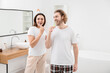 © Pixel-Shot - Lovely couple brushing teeth in bathroom