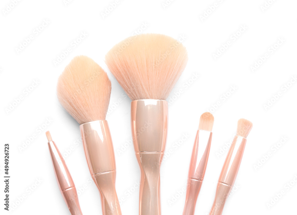 Set of makeup brushes isolated on white, top view