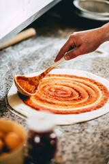 Wall Mural - Closeup of a man preparing a pizza