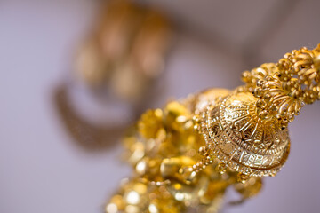 Wall Mural - Selective focus closeup of a beautiful shiny gold chandelier decoration for an Indian wedding