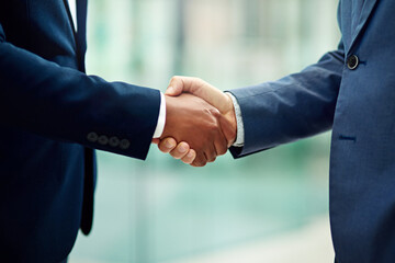Aufkleber - An introduction to business. Cropped shot of two unidentifiable businessmen shaking hands in the office.