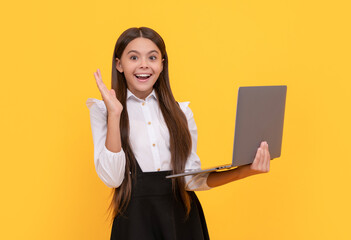 Canvas Print - typing school blog on computer. kid on video lesson. teen girl use laptop for blogging.