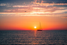 Silhouette Of A Ship Sailing In The Sea During Sunset
