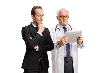 Professional man and a mature male doctor looking at a digital tablet